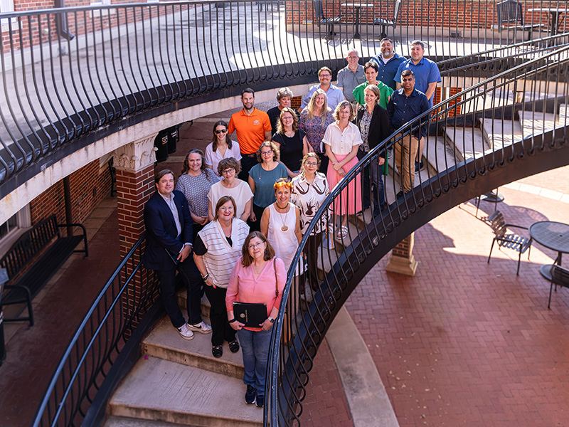 Group of people standing on a staircase.