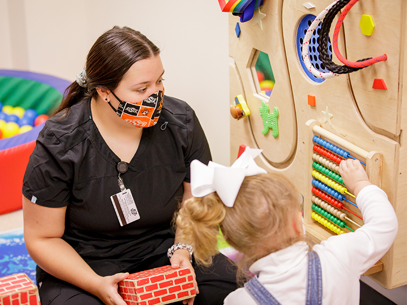 Female student working with a child.