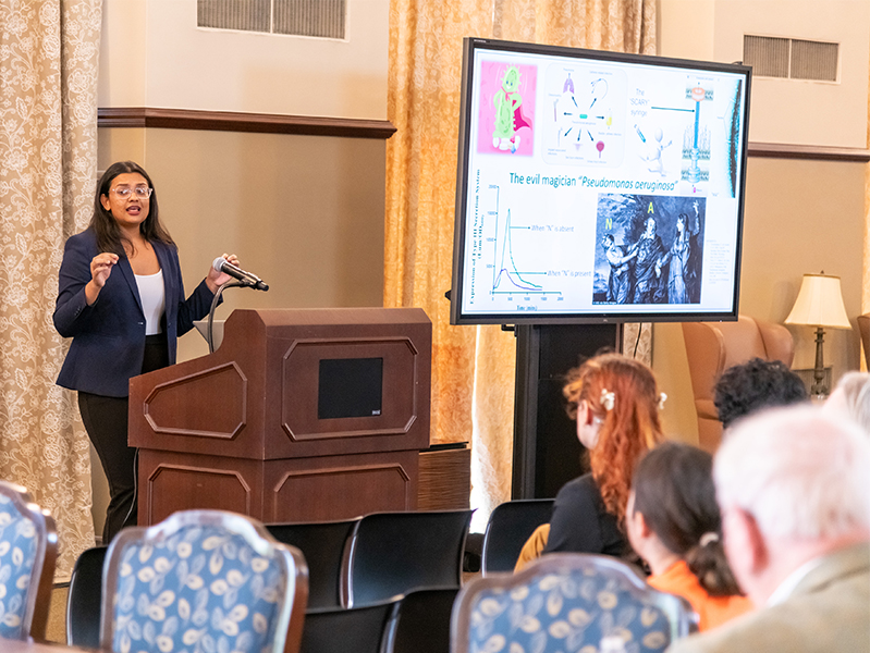 Student presenting at lecturn.