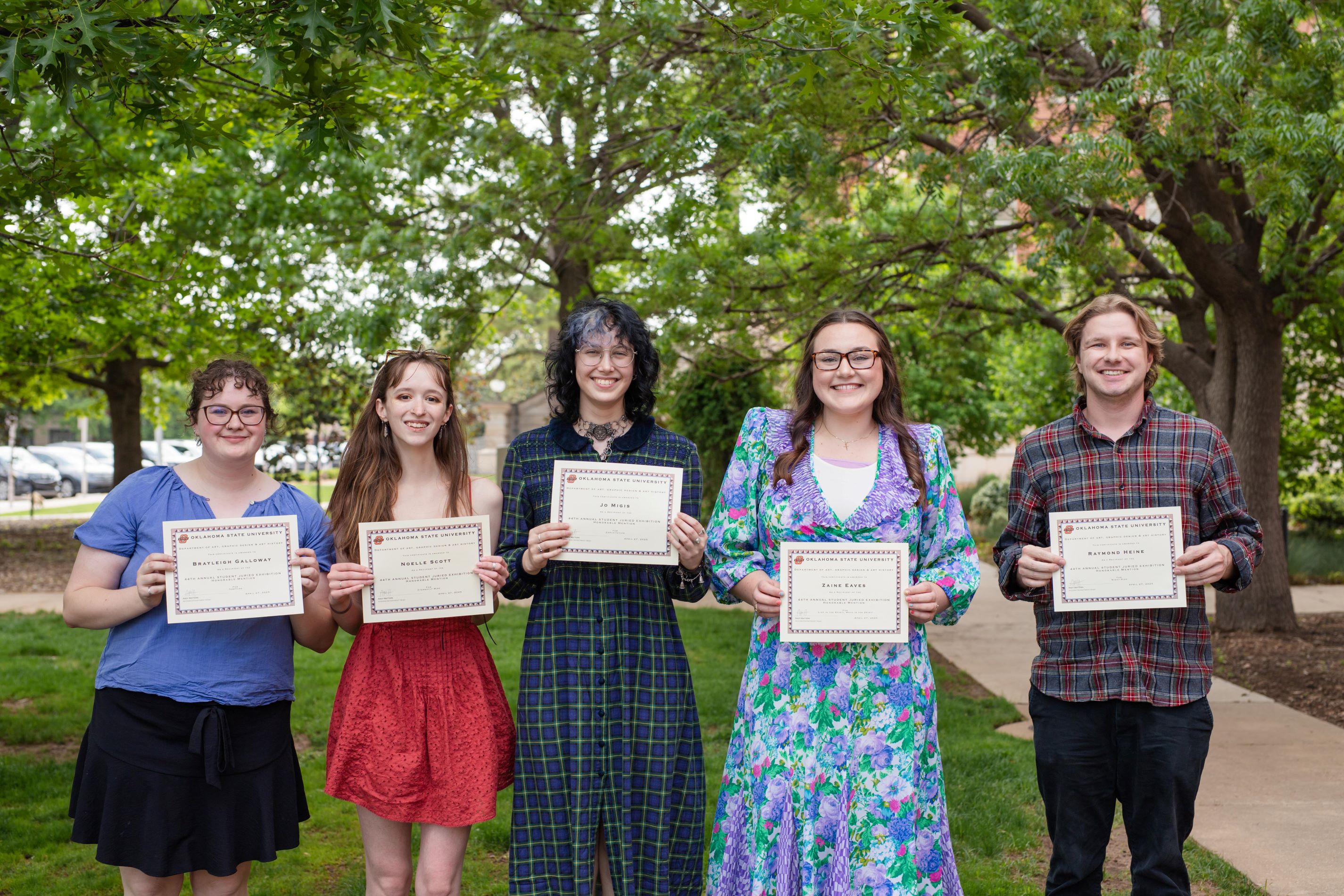View of students holding their award certificate