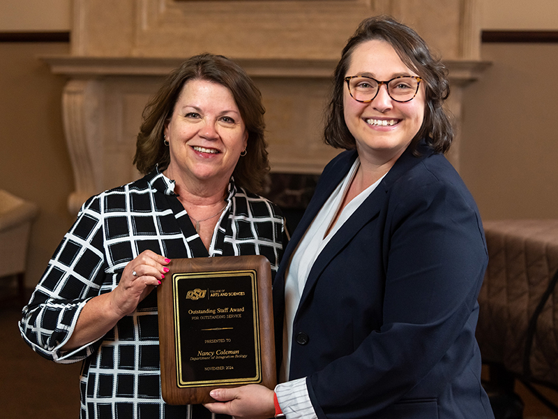 Nancy Coleman receiving her award from Dean Cro