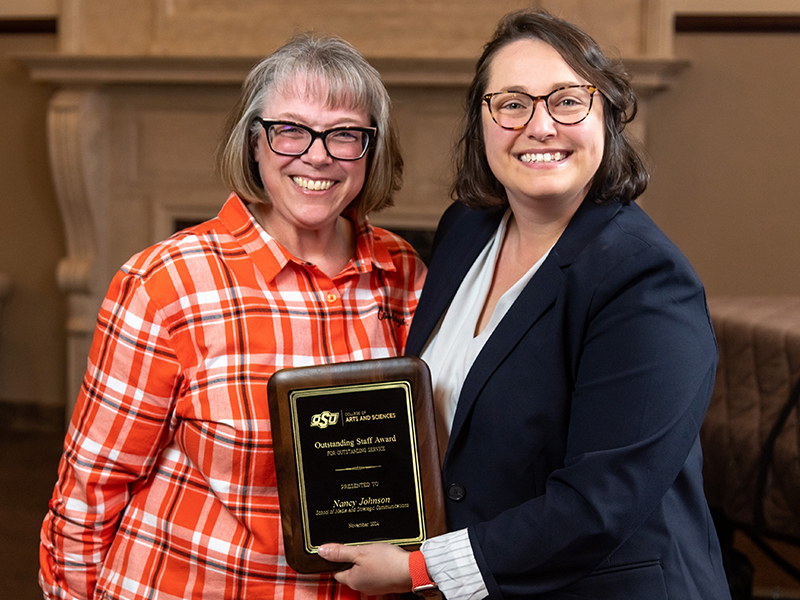 Nancy Johnson receiving her award from Dean Cro