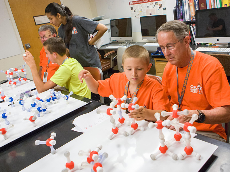 Students exploring a molecular model in a laboratory.