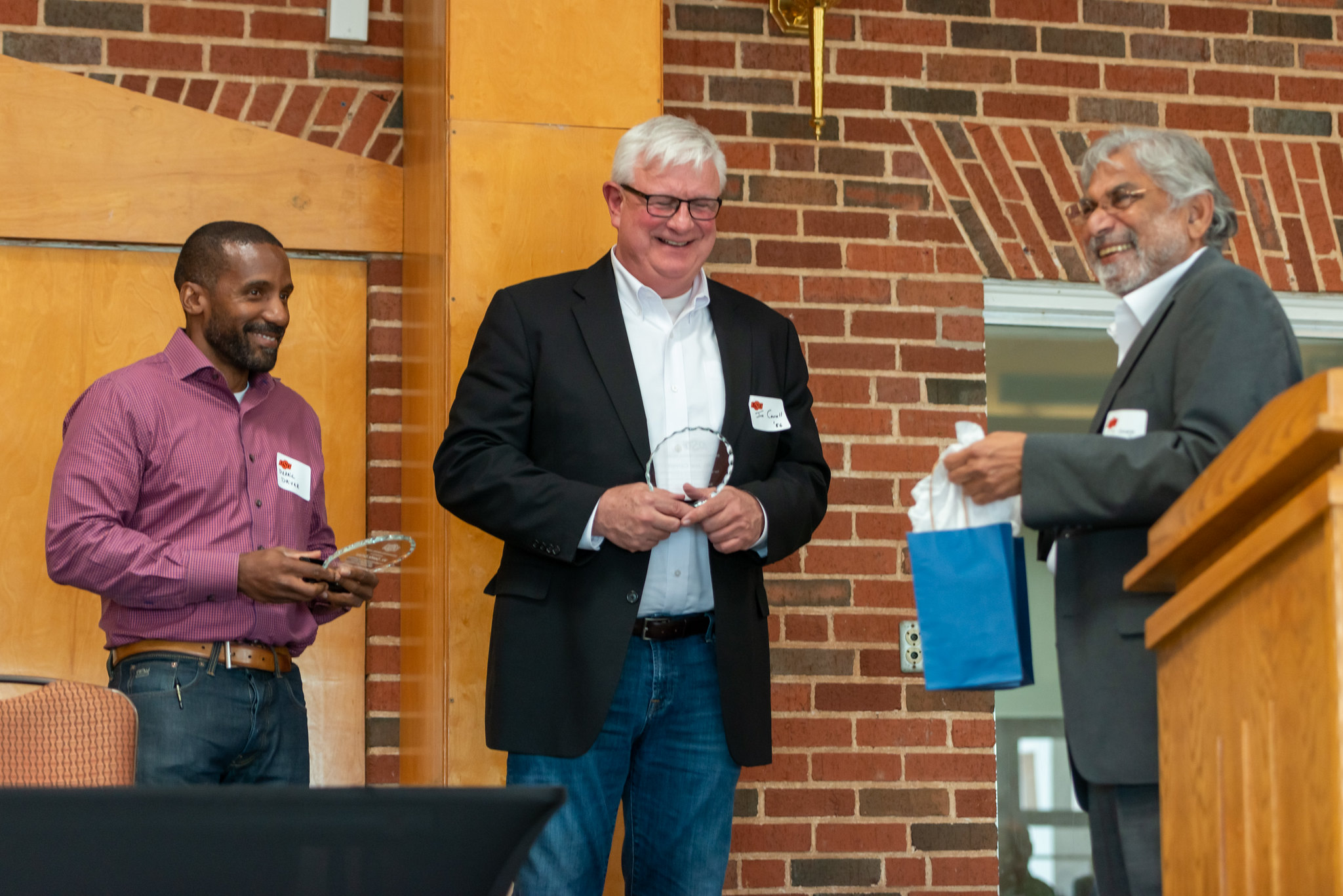 Derric Driver (Left) and Joe Carroll (Middle) are presented with a token of the Department's appreciation for their efforts by Dr. George (Right)