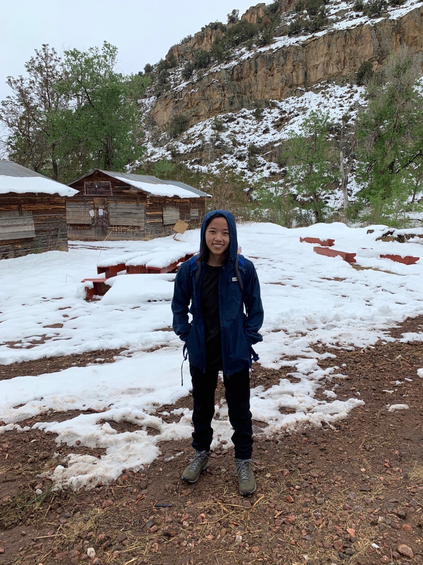 Student Emma standing outside of cabin in the snow, after the first snow fall. Student Emma standing outside of cabin in the snow, after the first snow fall.