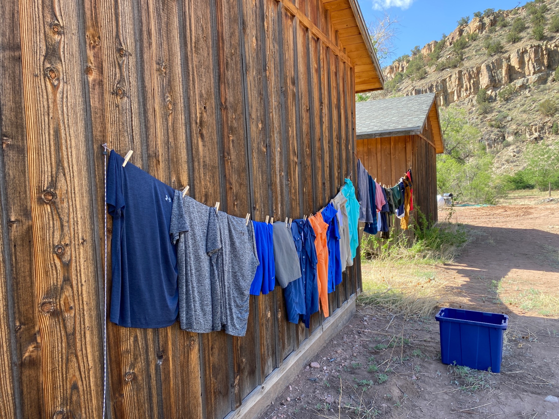 Clothes hanging on a clothes line against an outside cabin wall. Clothes hanging on a clothes line against an outside cabin wall.