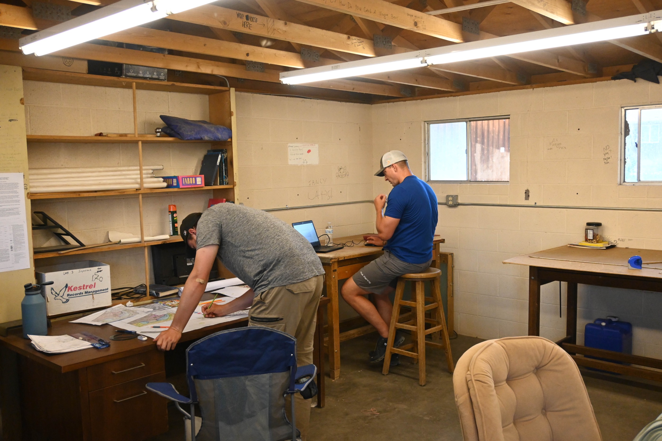 Two male students working at desks in the map room. Two male students working at desks in the map room.