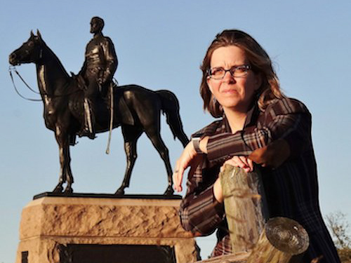 Dr. Murray woman posing by statue