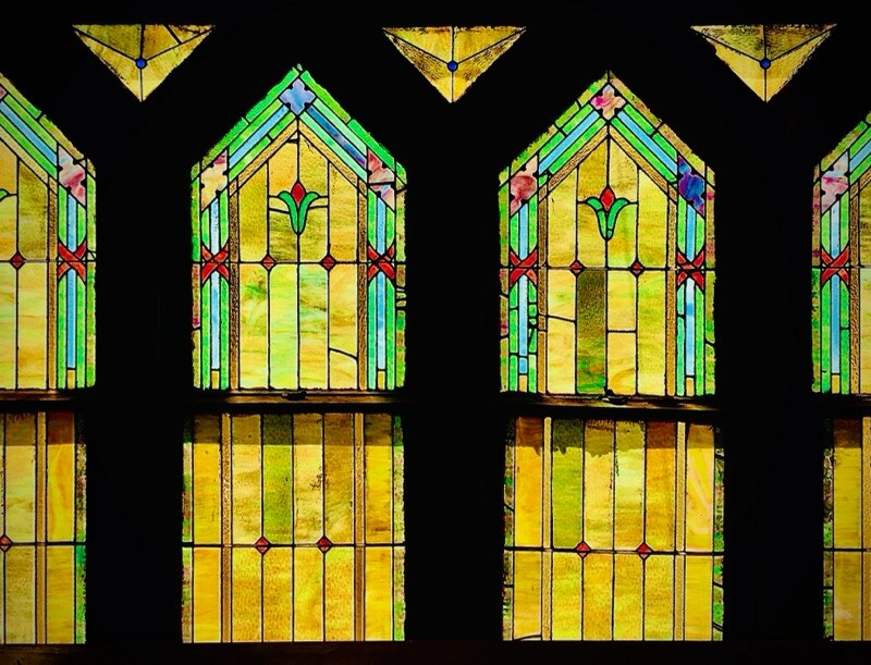 Yellow, green, and red stained glass window at Vernon AME church.