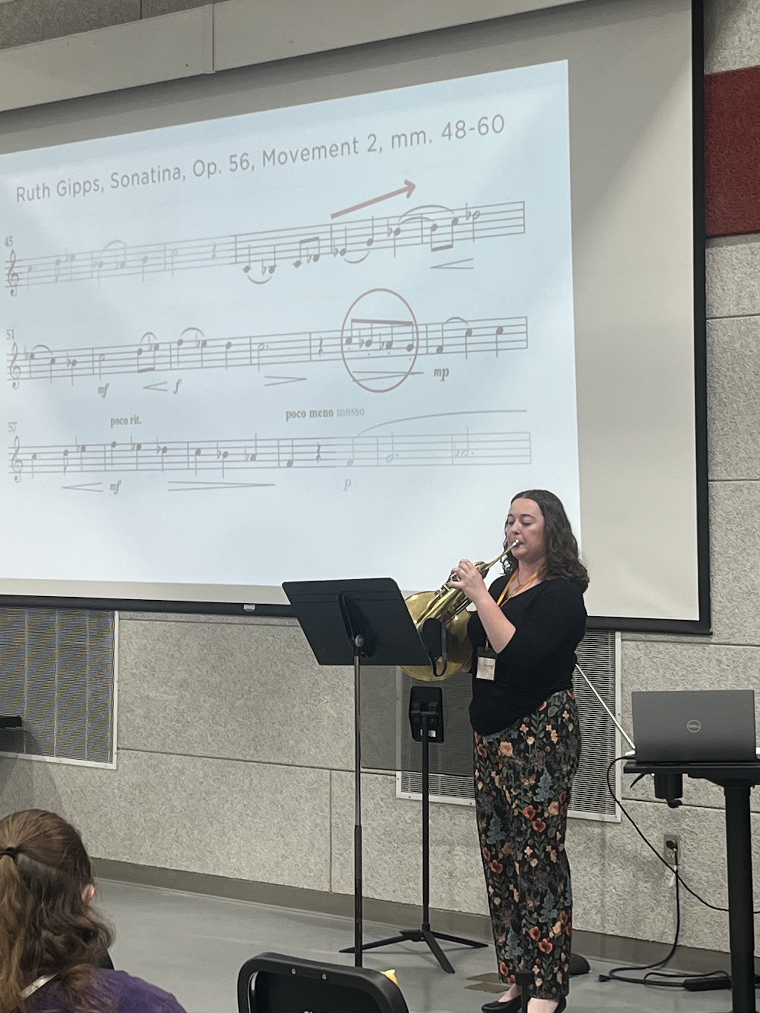 Student playing instrument for an audience