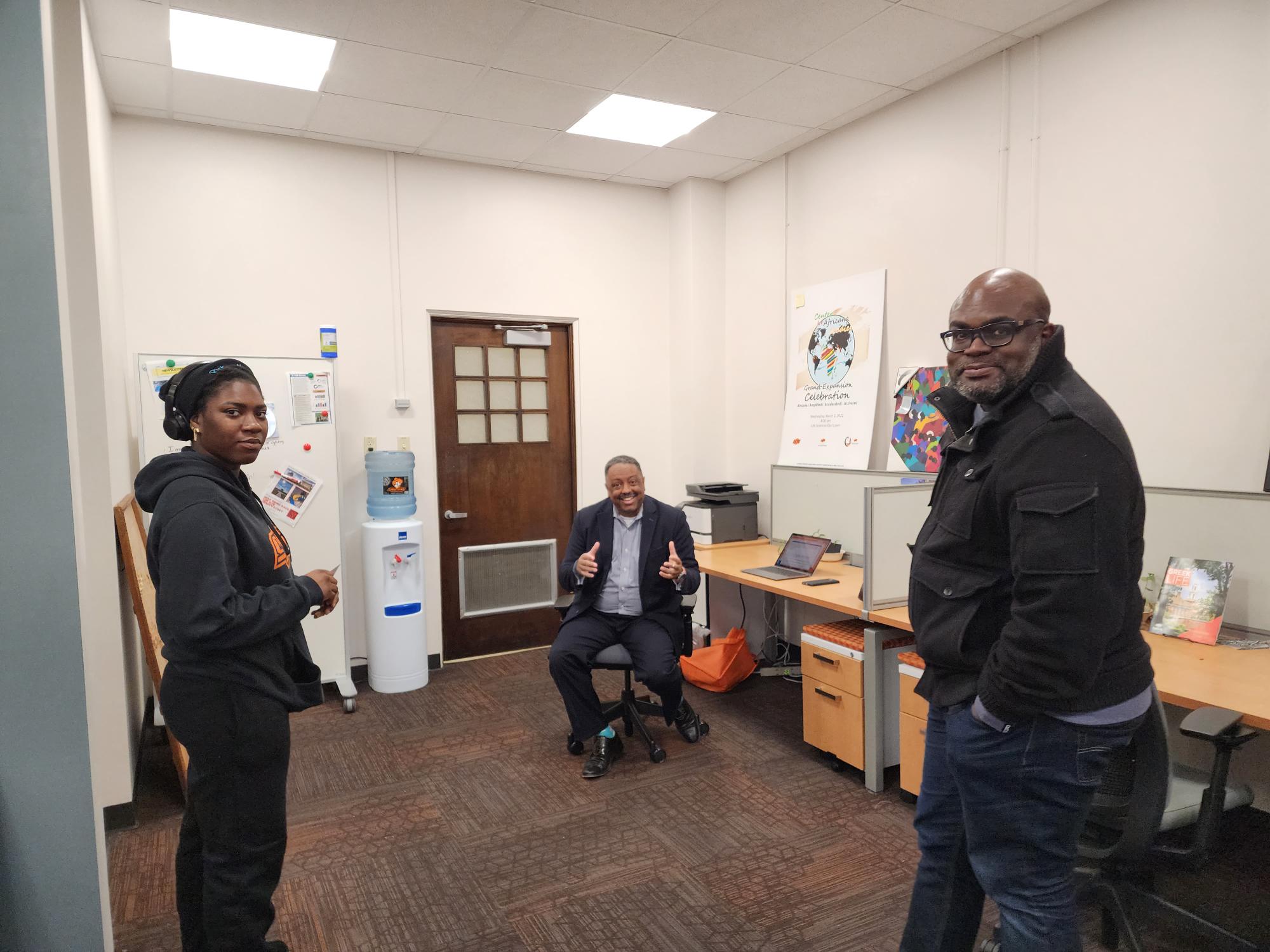 2 two male faculty members providing Center student with resource