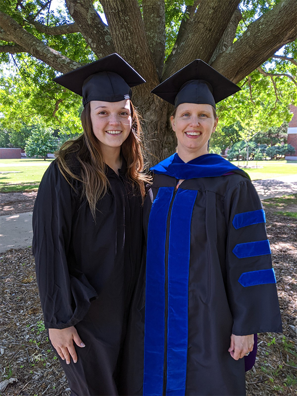 Brinley Cannon in graduation attire with Dr. Wozniak