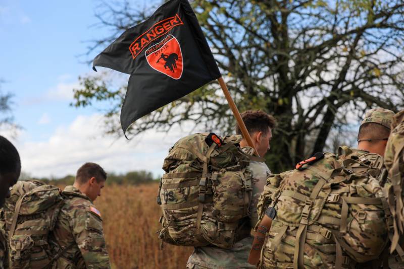 cadets carry a flag on a ruck march