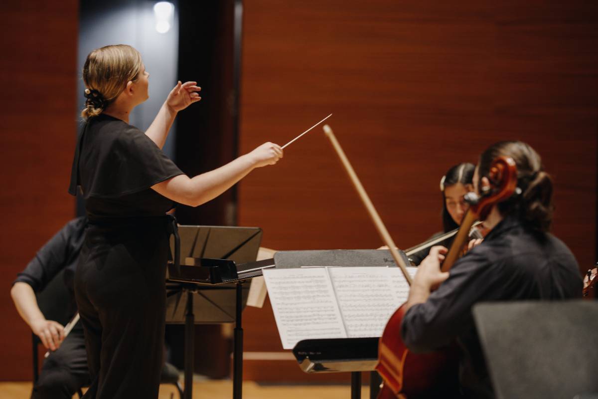 student conducting on stage