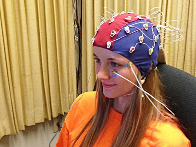 woman wearing an electrode cap on her head.