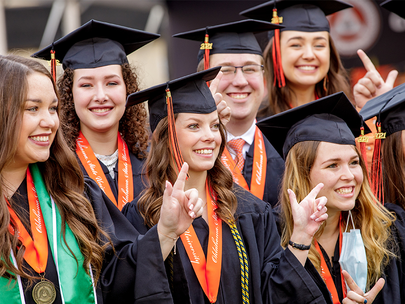 graduation.jpg A group of females in graduation cap and gown.