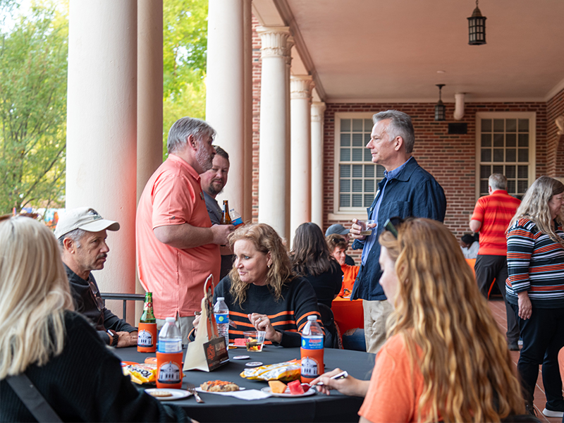 2024 homecoming reunion event tables on the patio with people chatting