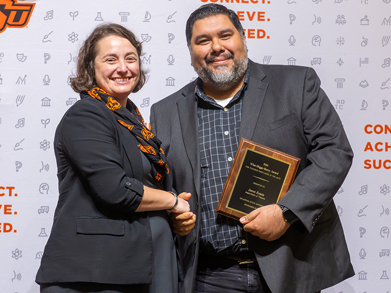 Jason Estala with his award and Dean Cro on stage at Convocation