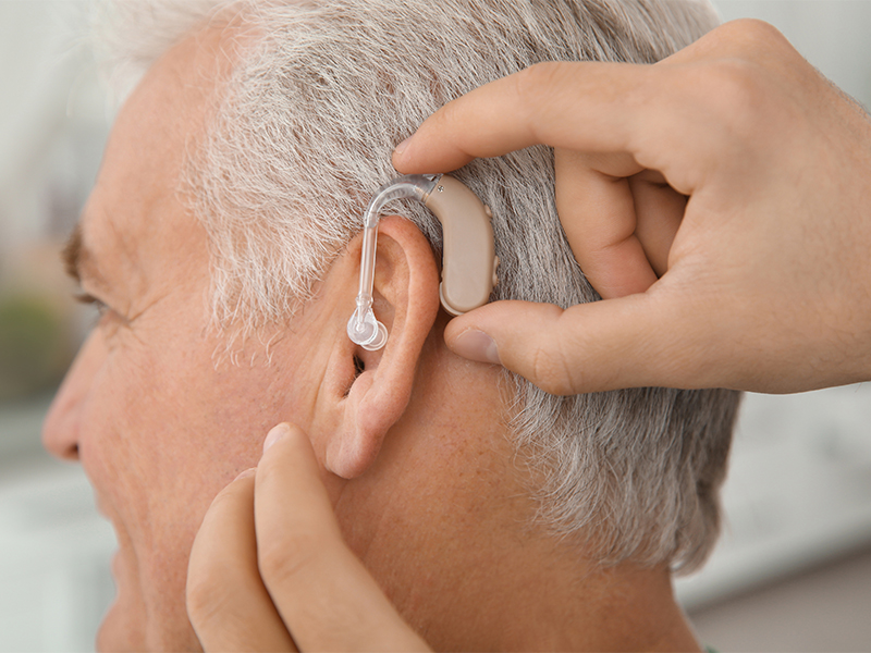 Man being fitted with hearing aid