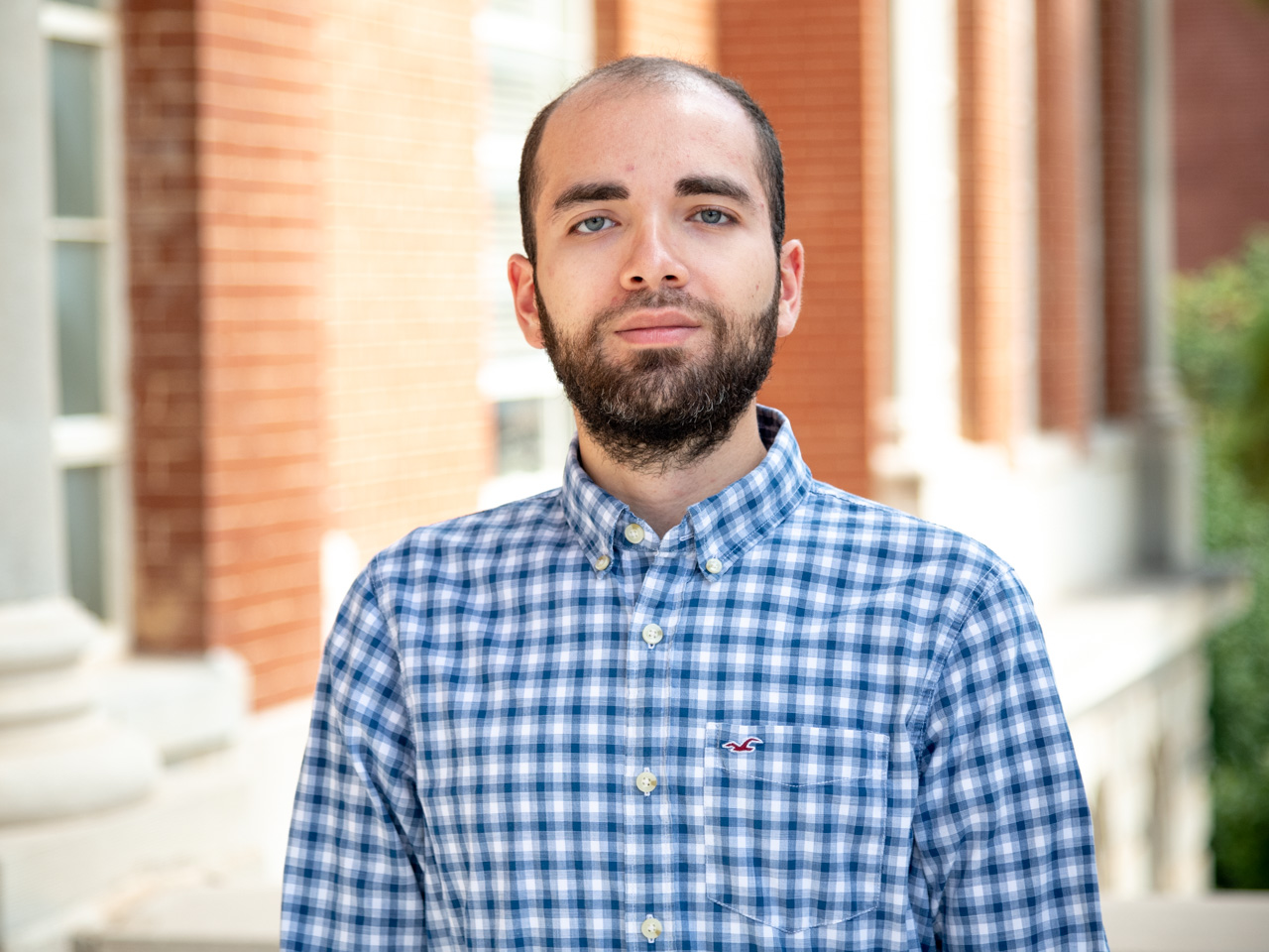 A man with a white and blue checkered shirt
