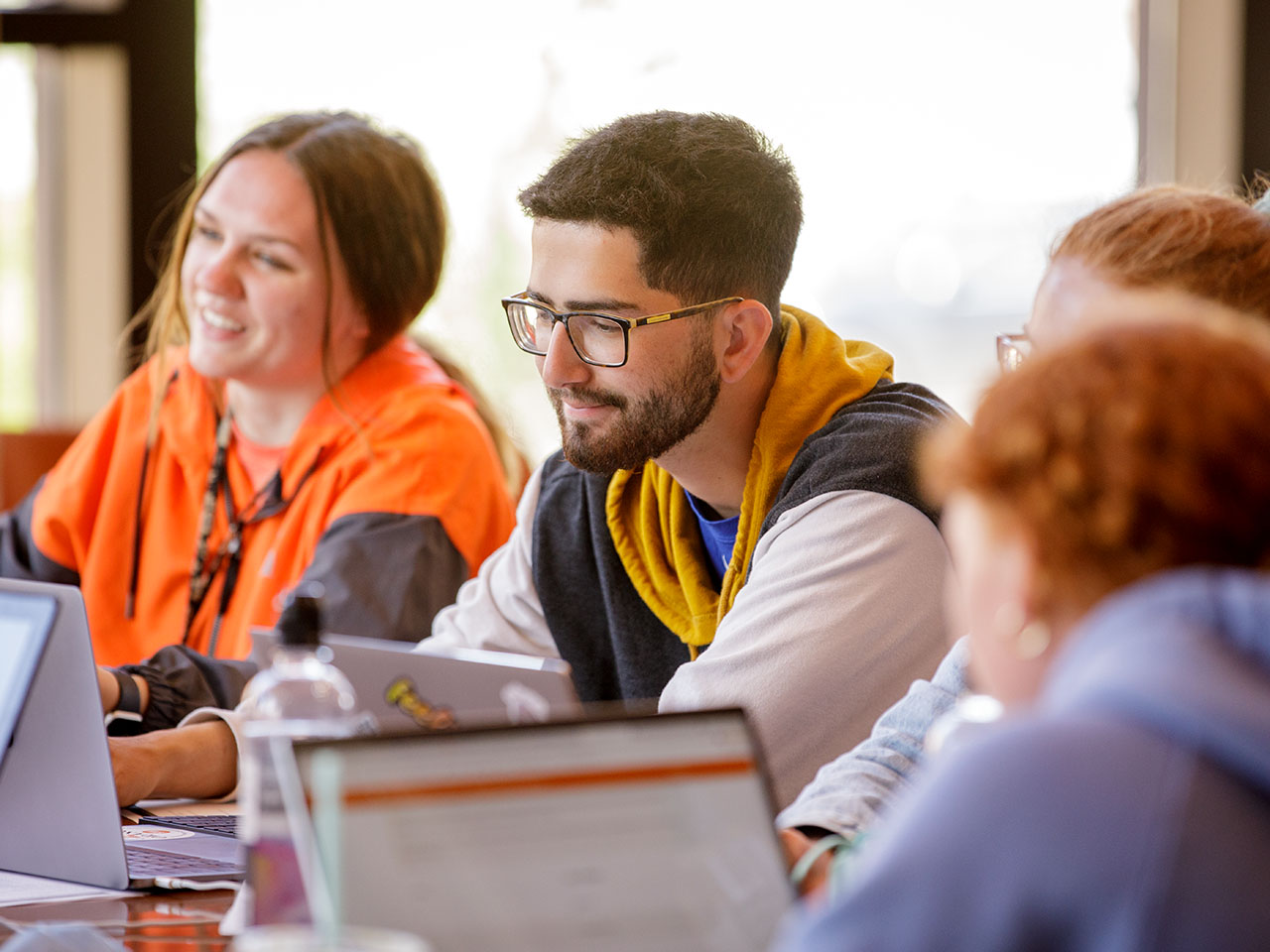 Students studying together on laptops