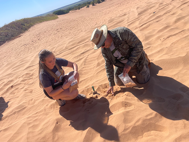 Collecting sand in baggies in the Gloss Mountains