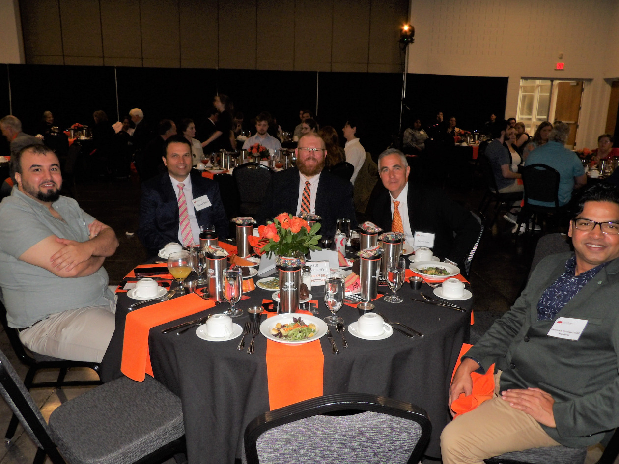 Mr. Khalid, Dr. Ahmed Ismail, Dr. Brandon Spencer, Mr. Barret and Mr. Sreejesh sitting together at the banquet dinner.