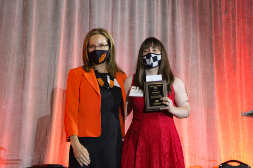 Dr. Camelia Knapp presenting an award to Ms. Autumn Graff.