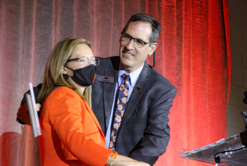 Dr. Camelia Knapp presenting an award to Dr. James Knapp.