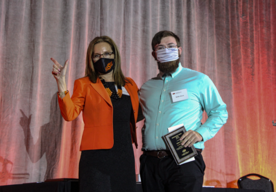 Dr. Camelia Knapp presenting an award to Mr. Kable Kleck.