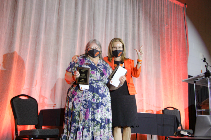 Mrs. Sandy Earls being given an award by Dr. Camelia Knapp.