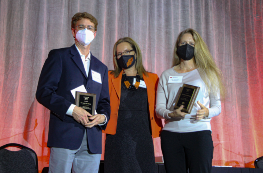 Dr. Daniel Lao Davila, Dr. Camelia Knapp and Dr. Natascha Riedinger posing on stage for a group photo.
