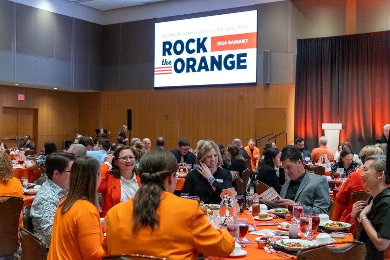 Everyone enjoying visiting while dining at the banquet. 