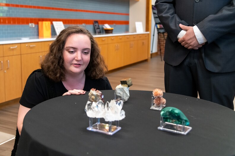 Elizabeth Scrudder looking at the minerals at the silent auction.
