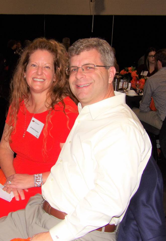 Mr. Steve and Mrs. Kristie Ferguson sitting together at dinner table during banquet.