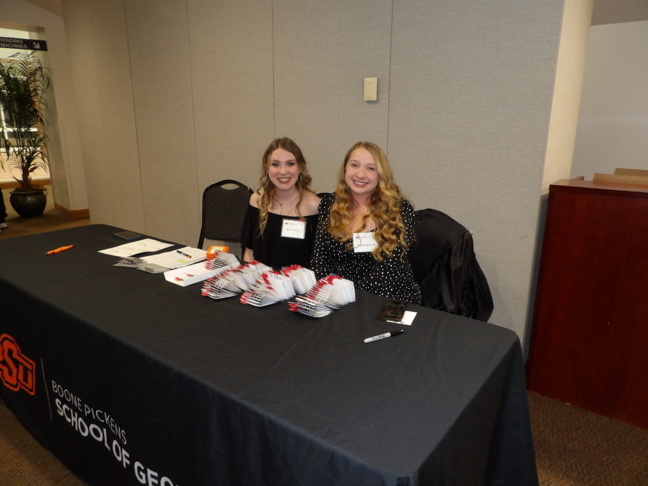 Ms. Megan Garrett and Ms. Izabelle Buentello checking people in at banquet.