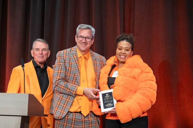 Mike Gaskins and Todd Halihan giving the Alumni Advisory Award to Kelsy Bufford on behalf of Estela Atekwana.