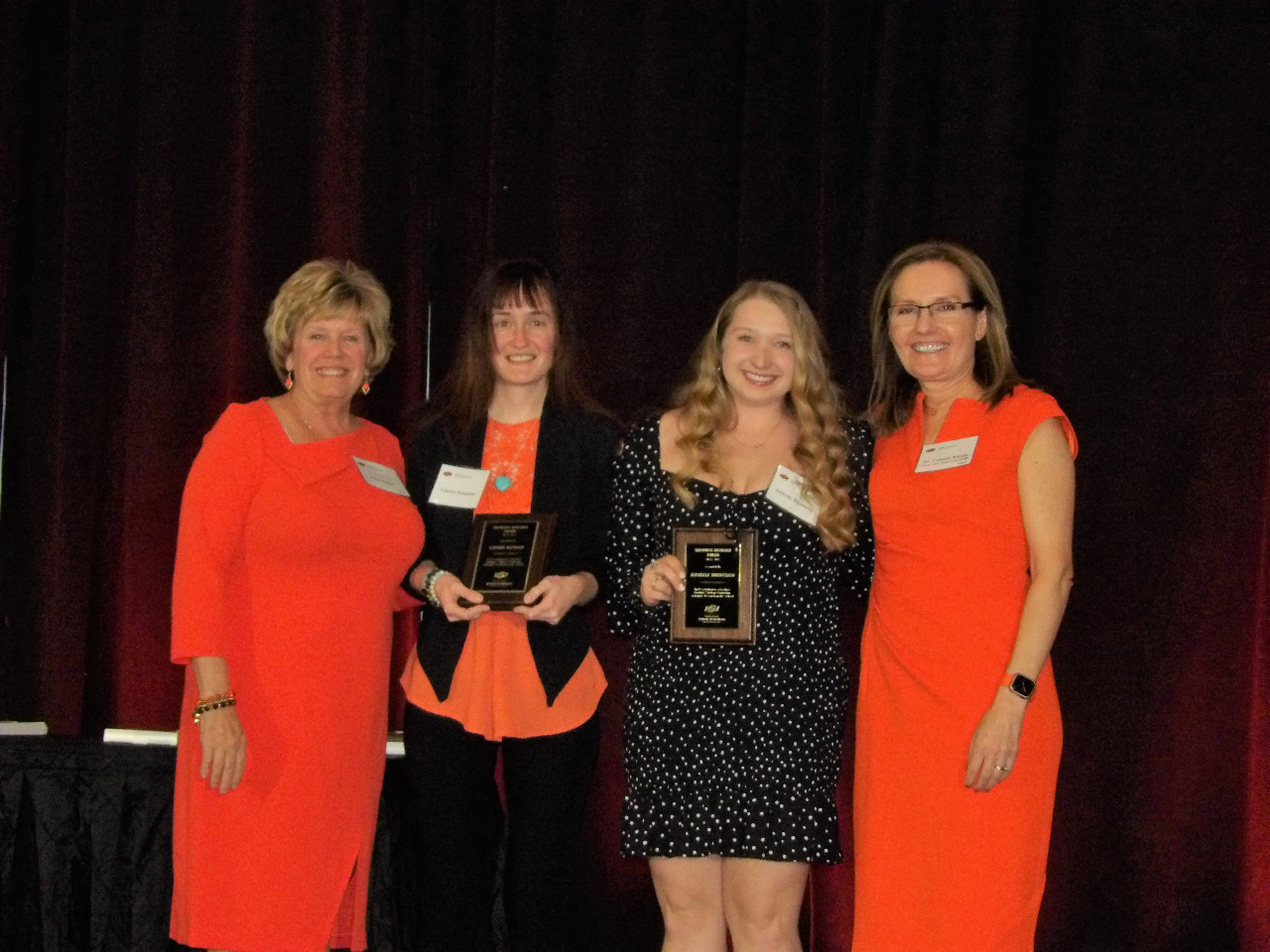 Mrs. Patty Walker and Dr. Camelia Knapp giving awards to both Ms. Lauren Haygood and Ms. Izabelle Buentello.