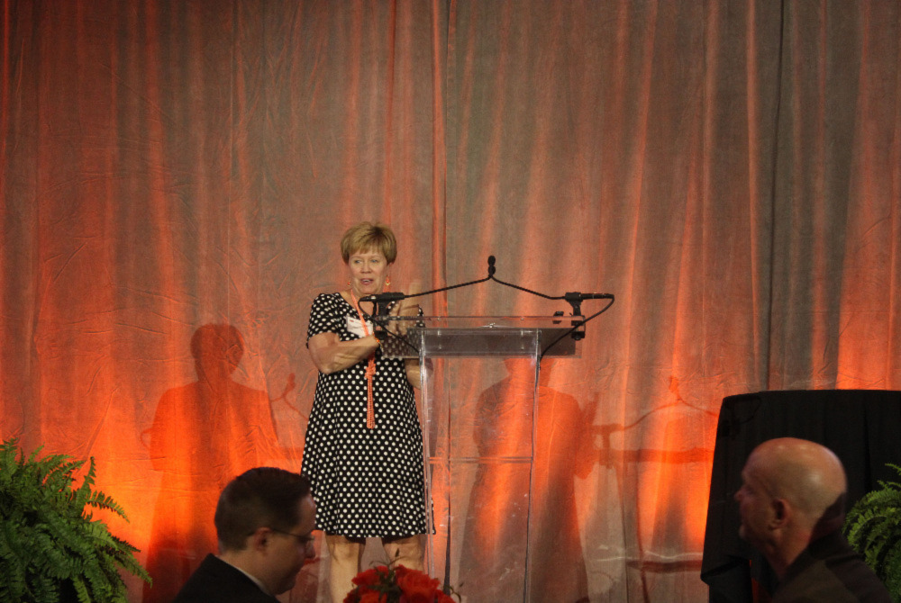 Mrs. Patty Walker at a podium announcing award winners.
