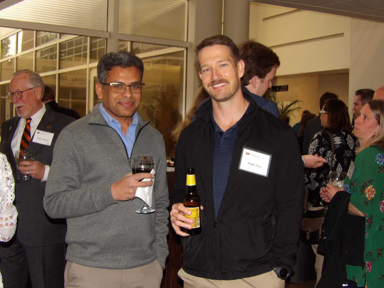 Dr. Pryiank Jaiswal and Mr. Buddy Price. visiting together before banquet begins.