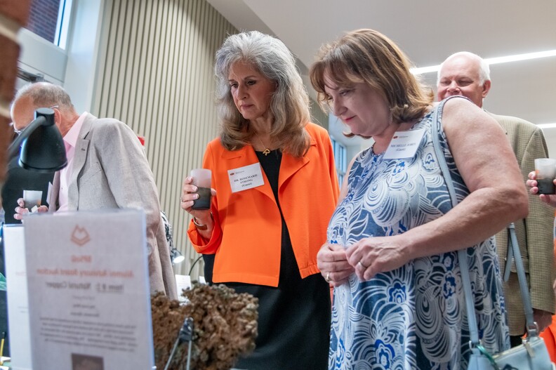 Rosemarie Strong and Tenia Spalvieri check out the silent auction.