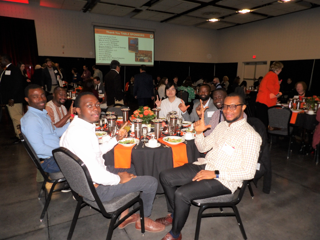 Seven male students showing their cowboy pride by make hand pistol signs.