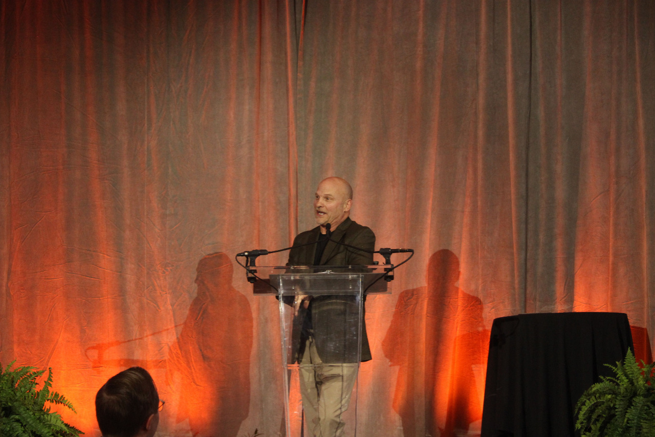 Mr. Terry Morse at a podium giving as speech.