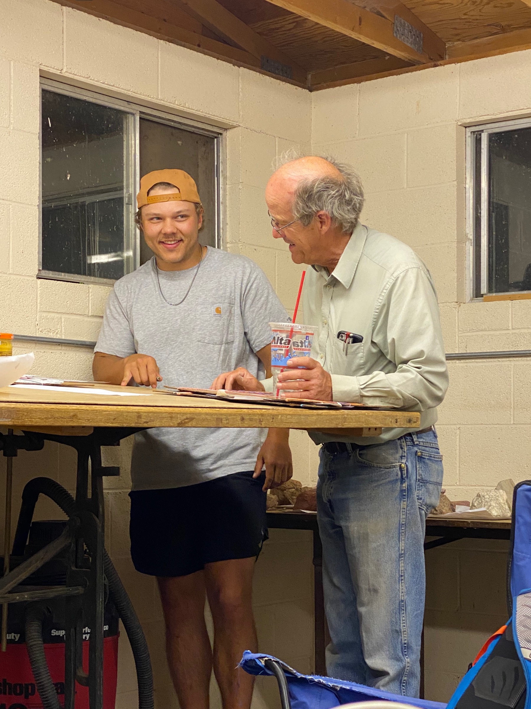 Dr. Jim Puckette helping a male student with paper work. Dr. Jim Puckette helping a male student with paper work.