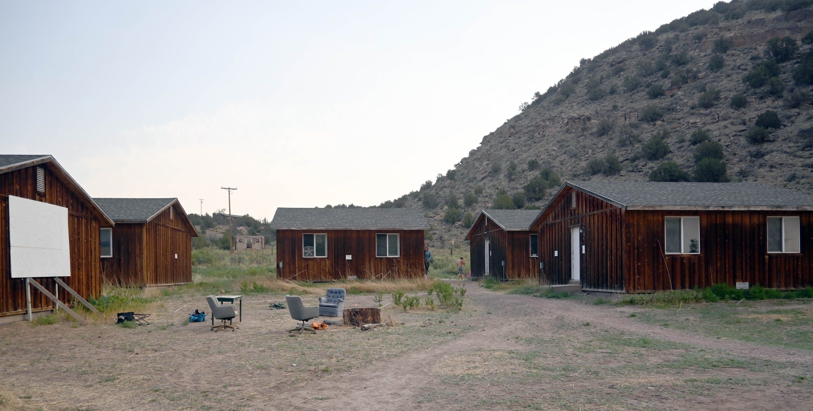 Outdoor view of the movie area with a projector screen and chairs. Outdoor view of the movie area with a projector screen and chairs.