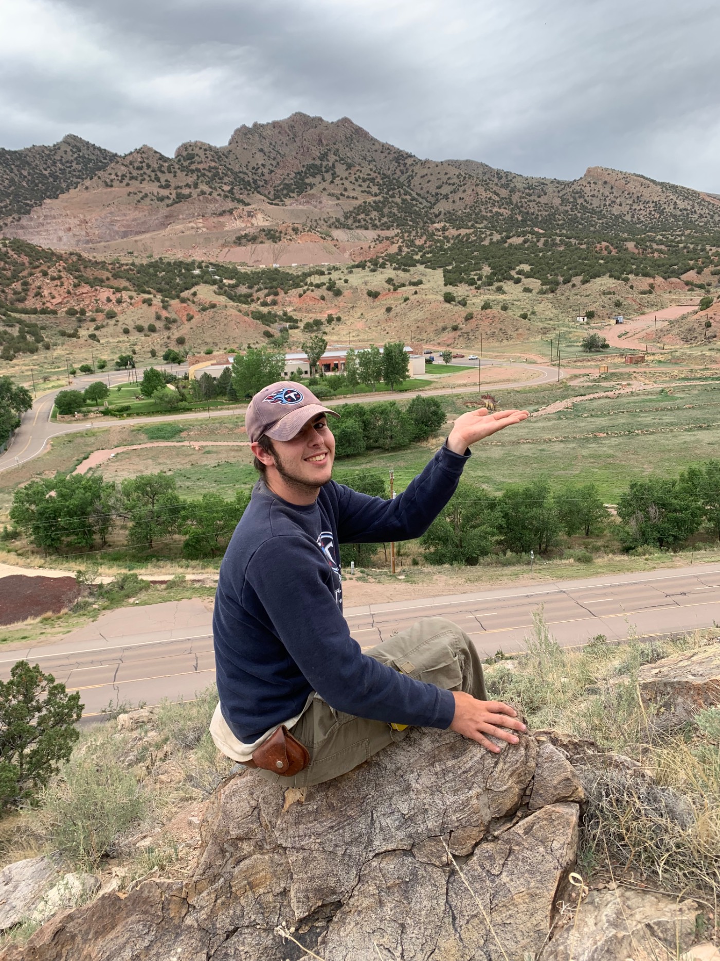 Student Jaren holding up a dinosaur statue near Skyline Drive in Cañon City.