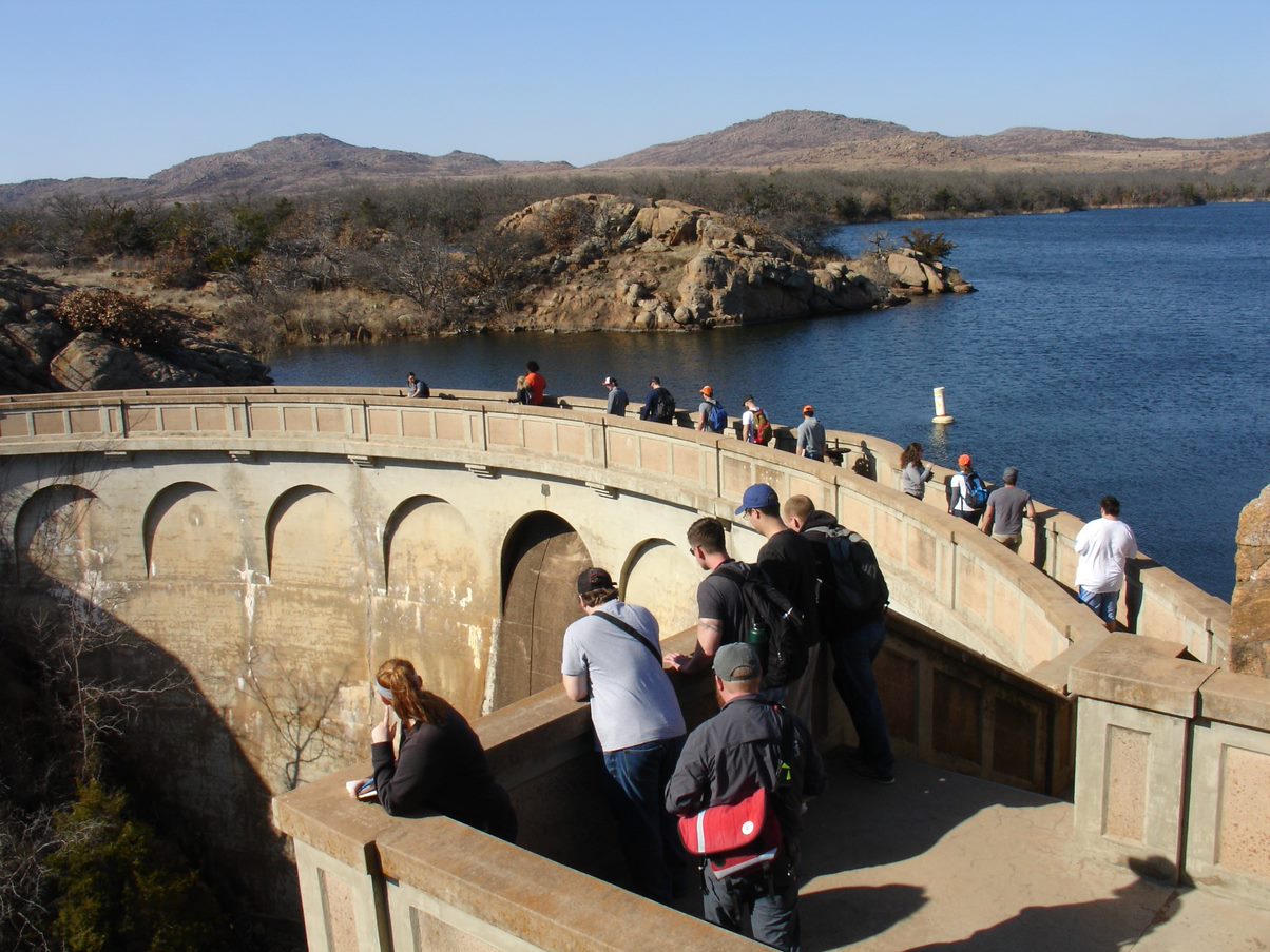 A large group of students at Reservoir looking at the view of water and mountains