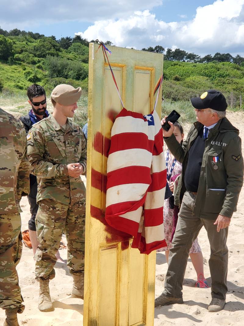 american_flag_beach.jpg American flag with military on beach