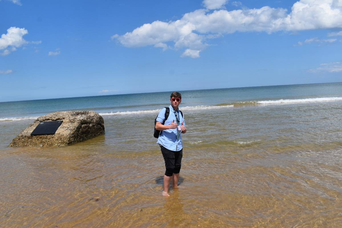 Student standing on the beach Student standing on the beach