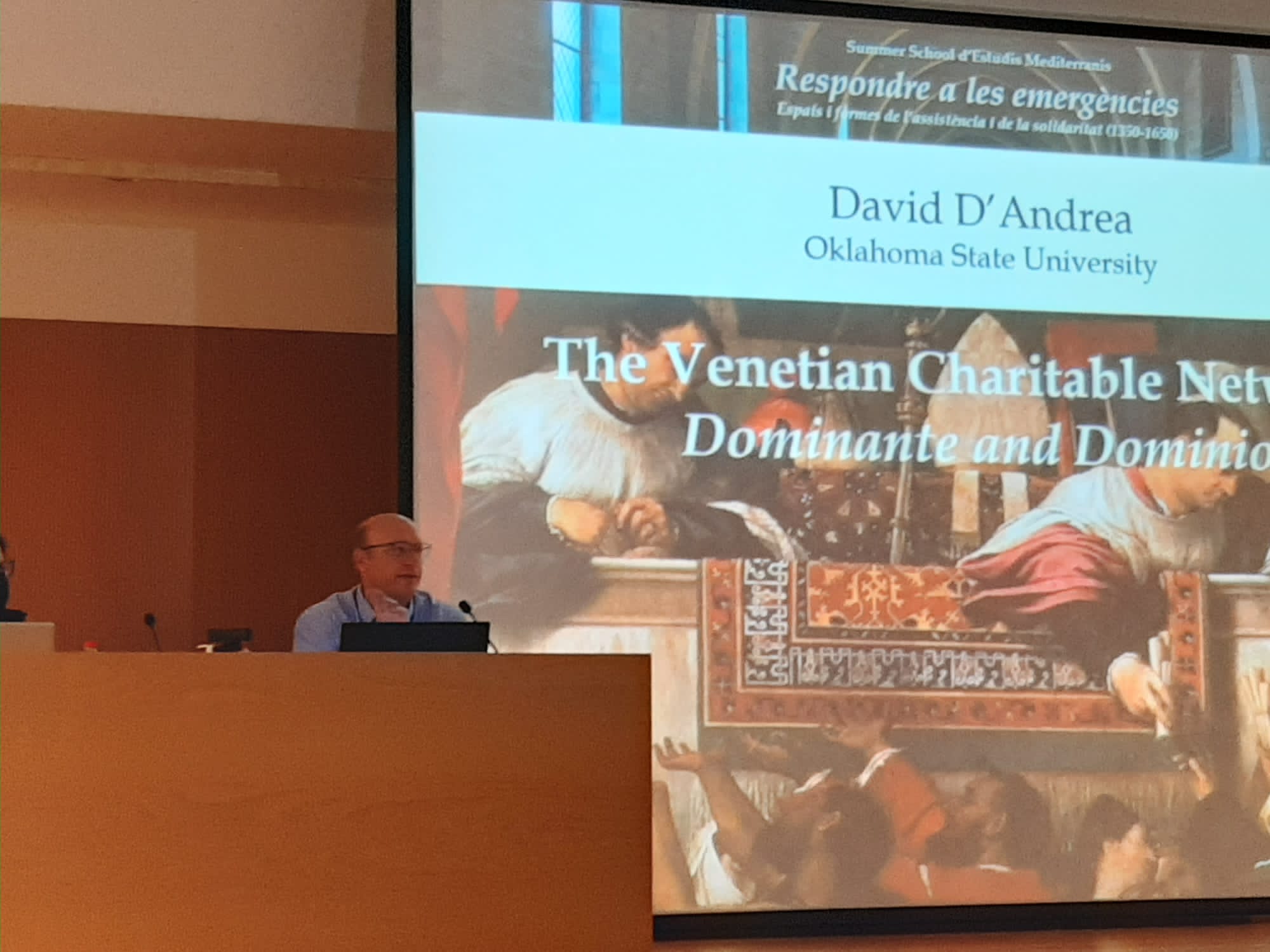 Dr. D'Andrea stands at a podium in Barcelona.